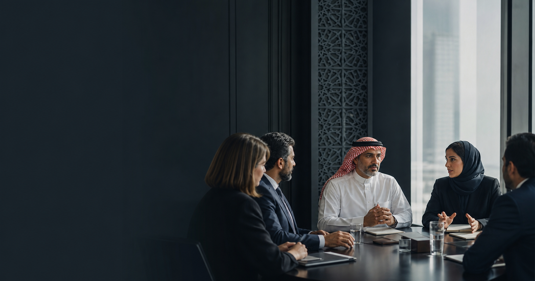 Saudi and international executives discussing strategy in a Riyadh boardroom