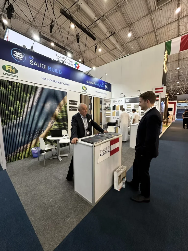 Austrian building products exhibitor meeting a visitor at Saudi Build in Riyadh.