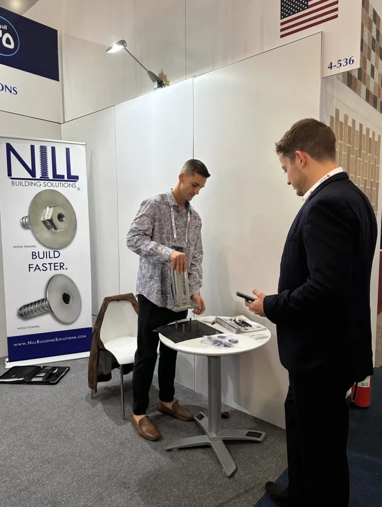 Product demonstration at a building solutions stand during the Saudi Build exhibition.
