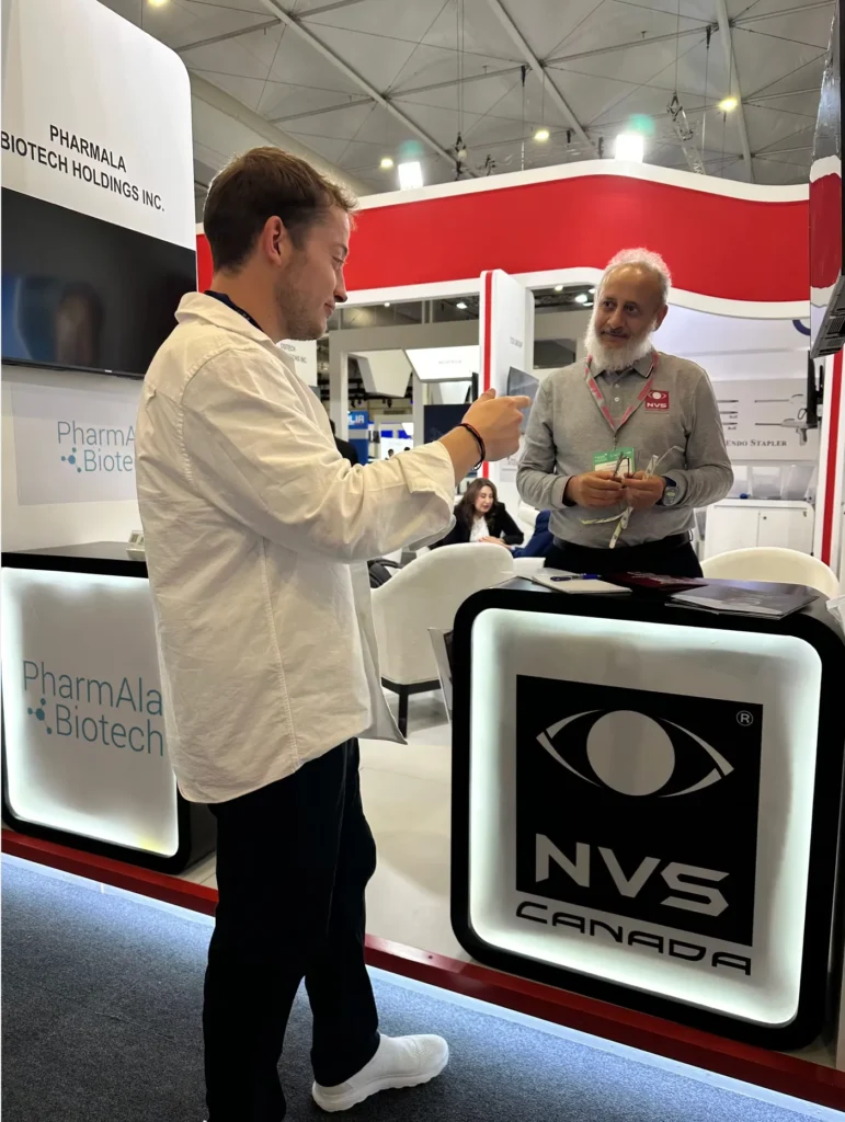 Business discussion with a Canadian medical technology exhibitor at the Global Health Exhibition.