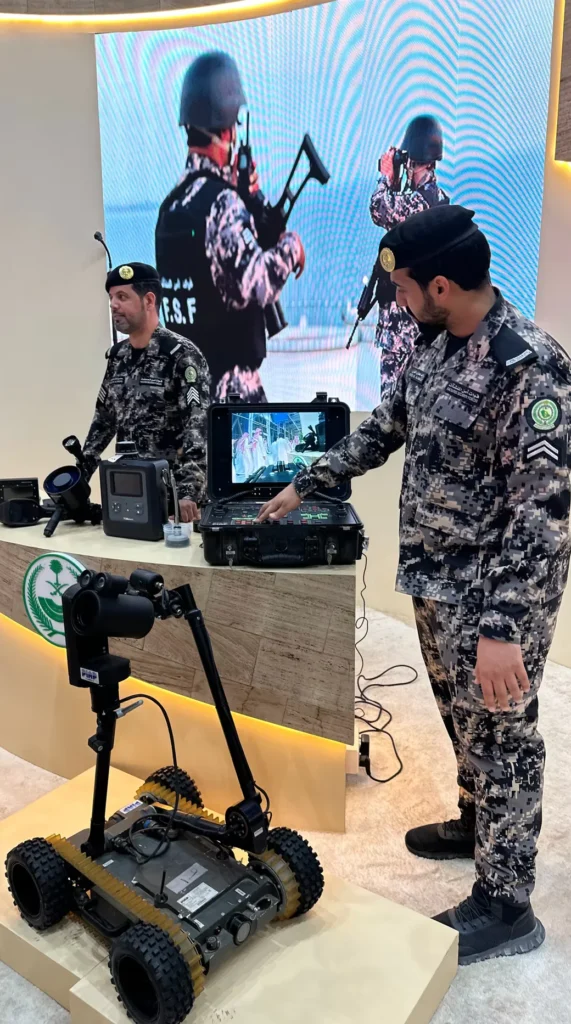 Saudi Civil Defence officers demonstrating a remote-controlled inspection robot.