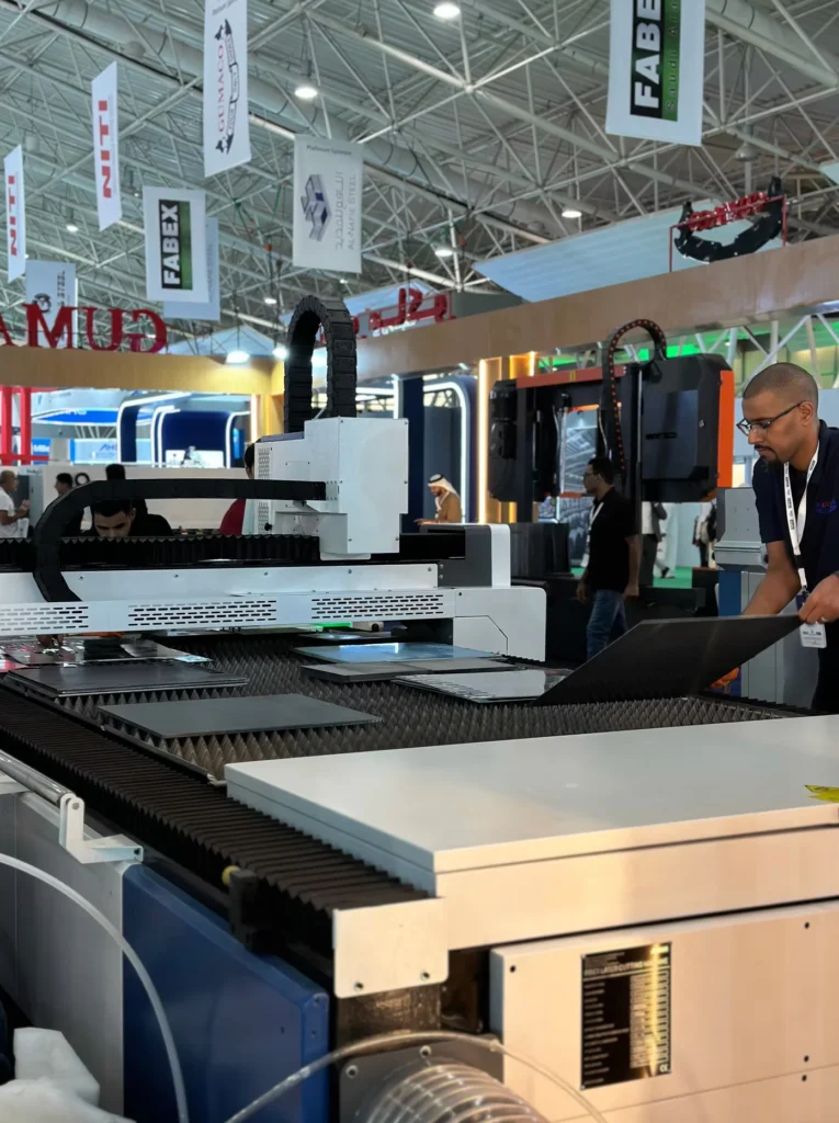 Industrial metal cutting machine operating on sheet metal at FABEX Saudi Arabia.