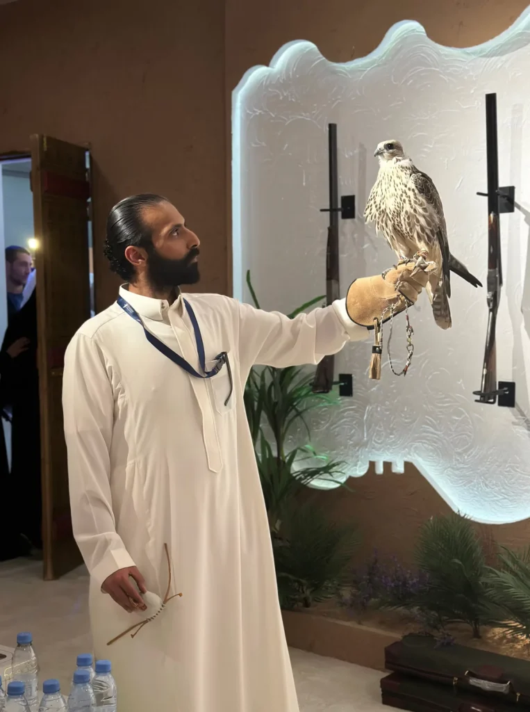 Falconer presenting a falcon in the cultural area of the exhibition.
