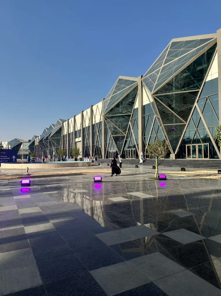 Exterior of the Global Health Exhibition venue in Riyadh under a clear blue sky.