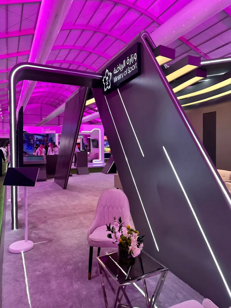 Purple-lit Ministry of Sport exhibition stand at Cityscape Global.