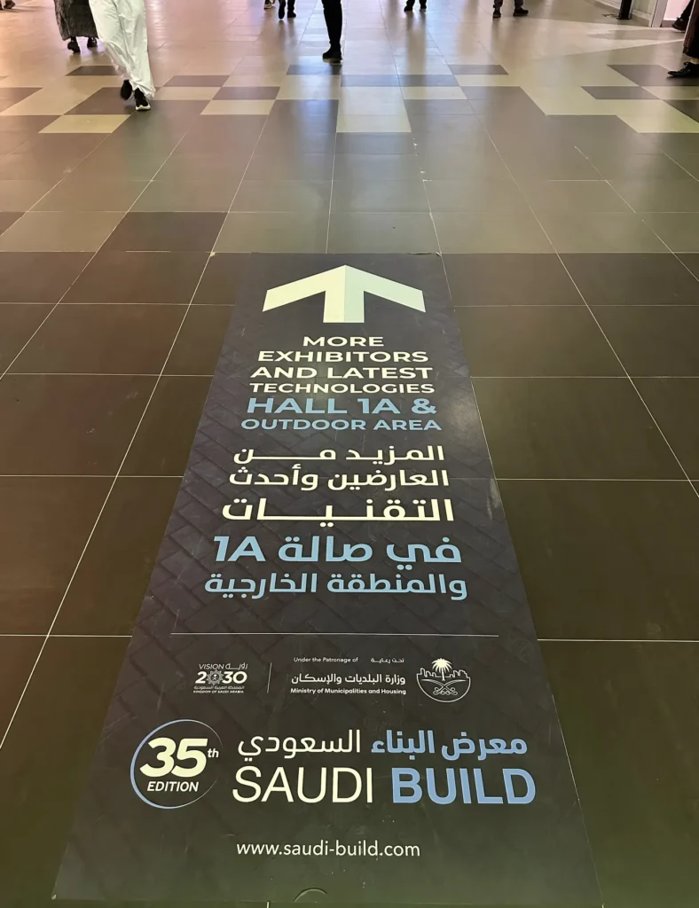 Floor sign directing visitors to exhibitors and technology displays at Saudi Build.